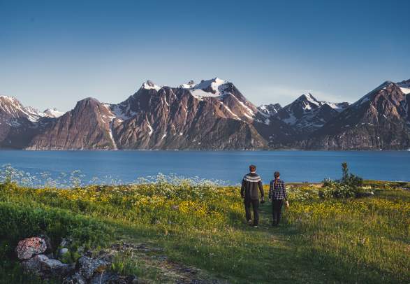 Two people in front of the Lyngenfjord Alps