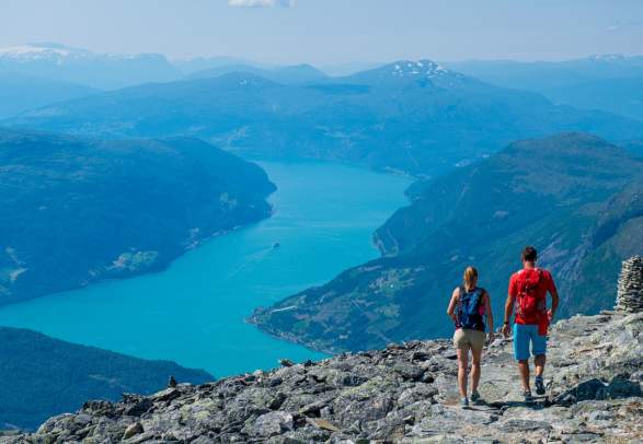 A couple hiking in the mountains in Nordfjord on a summer day