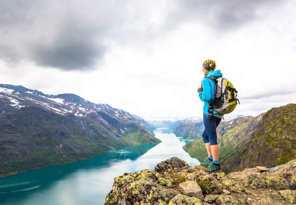 A woman enjoying the view of Lake Gjende from the top of Besseggen in Jotunheimen, Eastern Norway