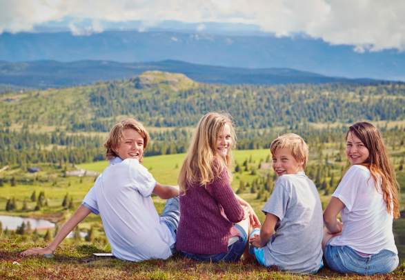 Four kids taking a break on a mountain hike in Gol in Hallingdal, Eastern Norway