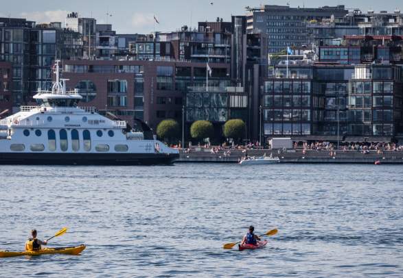 Two people kayaking near the Aker brygge wharf in Oslo, Eastern Norway