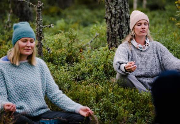 Two women meditation in the Finnskogen forest in Hedmark county