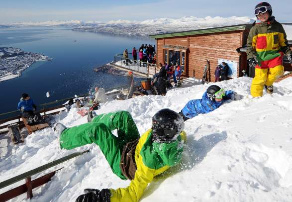 People playing in the snow at Narvikfjellet ski resort in Narvik, Norway