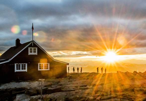 People watching the sunset at the Fannaråken cabin in Jotunheimen, Norway