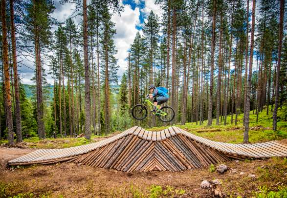 A person cycling on an obstacle in Trysil bike arena in Eastern Norway