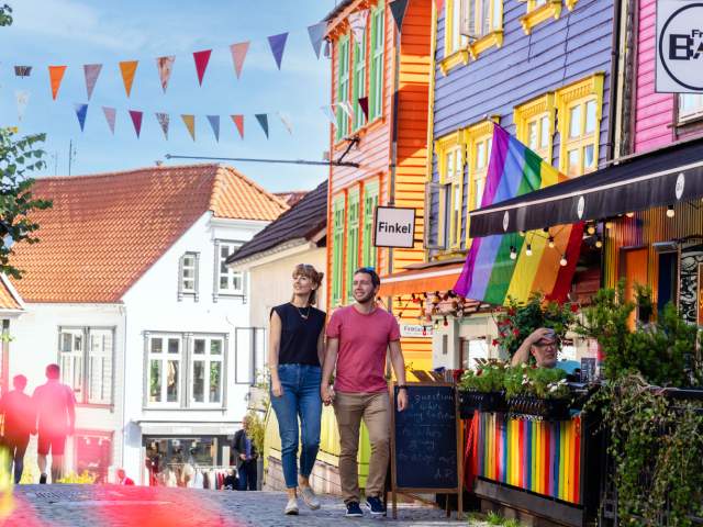A couple walking in Fargegaten (the street of color)