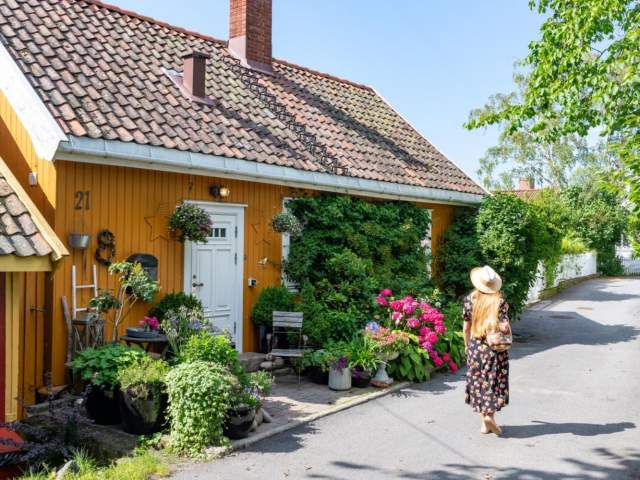 Woman walking in Badehusgata in Drøbak on a summerday, Follo