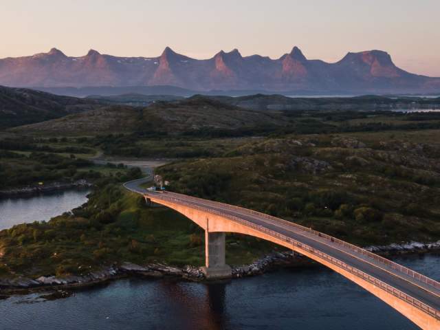 A bridge connecting Herøy to another island in Helegeland, Northern Norway. In the background, the mountain range The seven sisters.