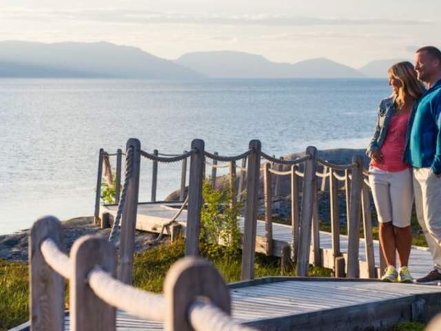 Couple visiting The Rock Carvings in Alta, Northern Norway
