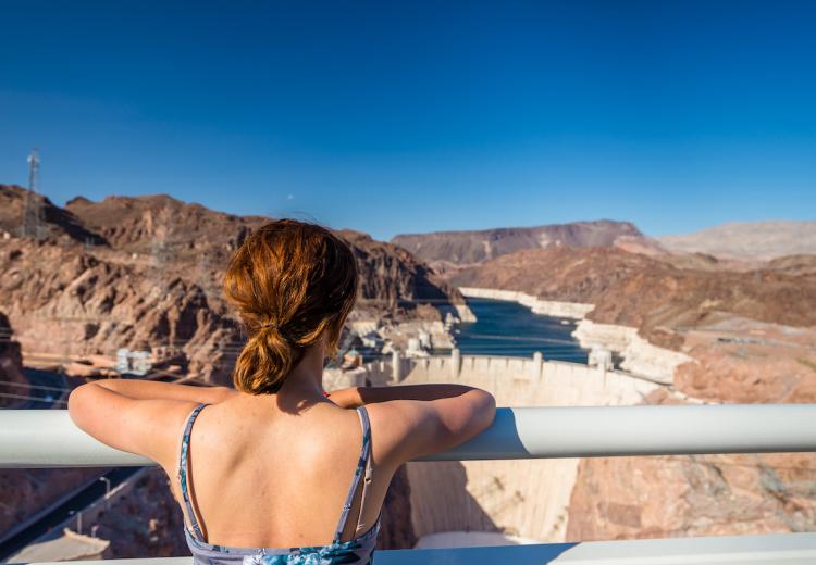 Woman enjoying the view of the Hoover Dam from across the dam.