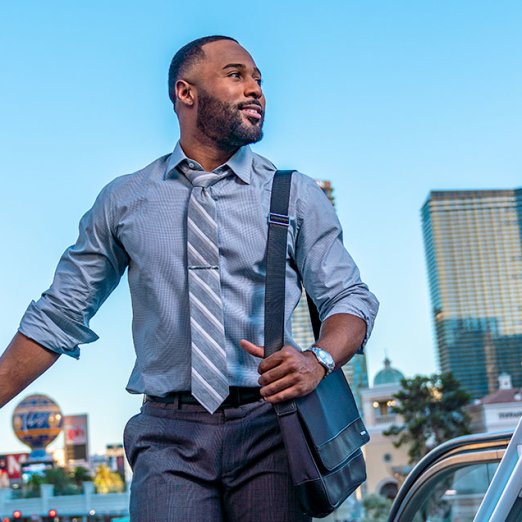 man in business attire at top of escalator in Las Vegas
