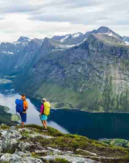 A couple enjoying the view of the Hjørundfjord in Norway