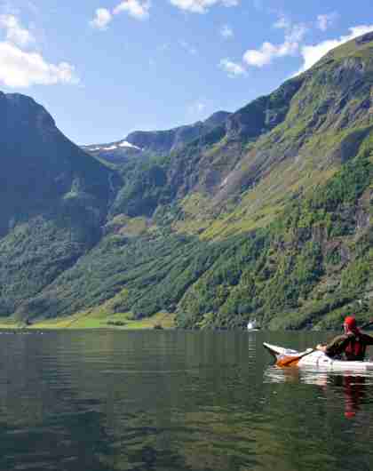 A person paddling in the Nærøyfjord in Fjord Norway