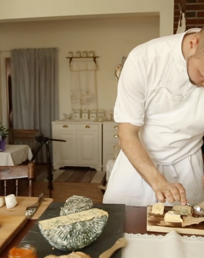 The chef at Gangstad Gårdsysteri in Trøndelag, Norway is arranging cheeses on a plate