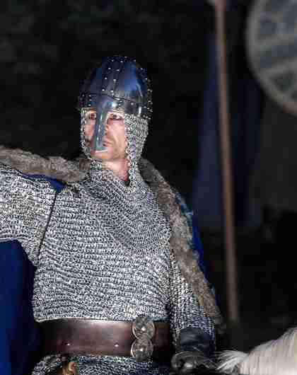 An actor playing Saint Olav waving from a horse at Stiklestad in Trøndelag