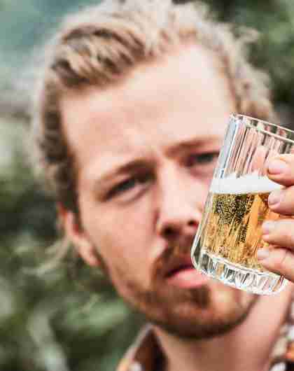 A man tasting Cider from Aga Sideri in Hardangerfjord in Fjord Norway