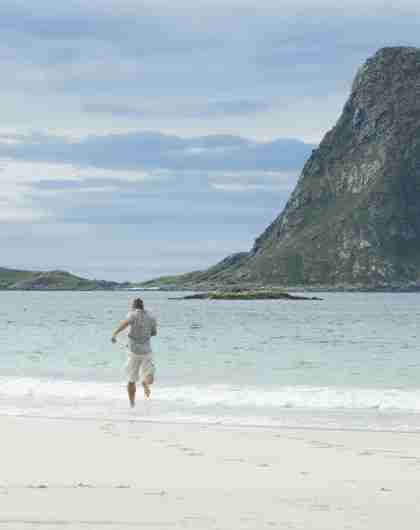 Two people running on a beach at Andøy in Vesterålen, Norway