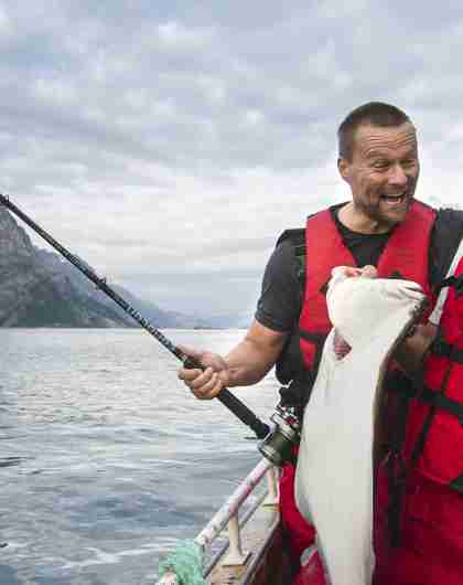 Two men in a boat sea fishing in Tromsø
