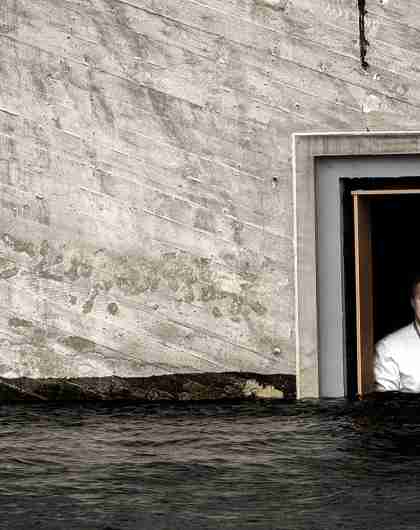 Chef Nicolai Ellitsgaard is looking out of the window at the partially submerged restaurant Under in Lindesnes, Southern Norway