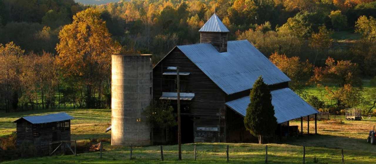 Old fashioned barn surrounded by fall color}