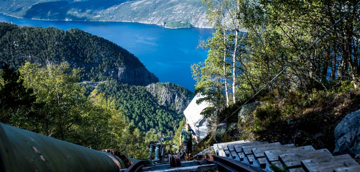 A man climbing up the Flørli staircase above the Lysefjord in Rogaland, Norway