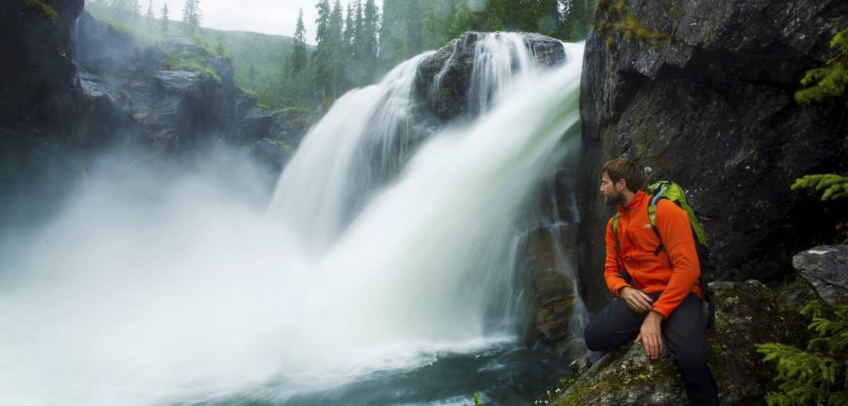 A man looking at Rjukandefossen waterfall in Hemsedal