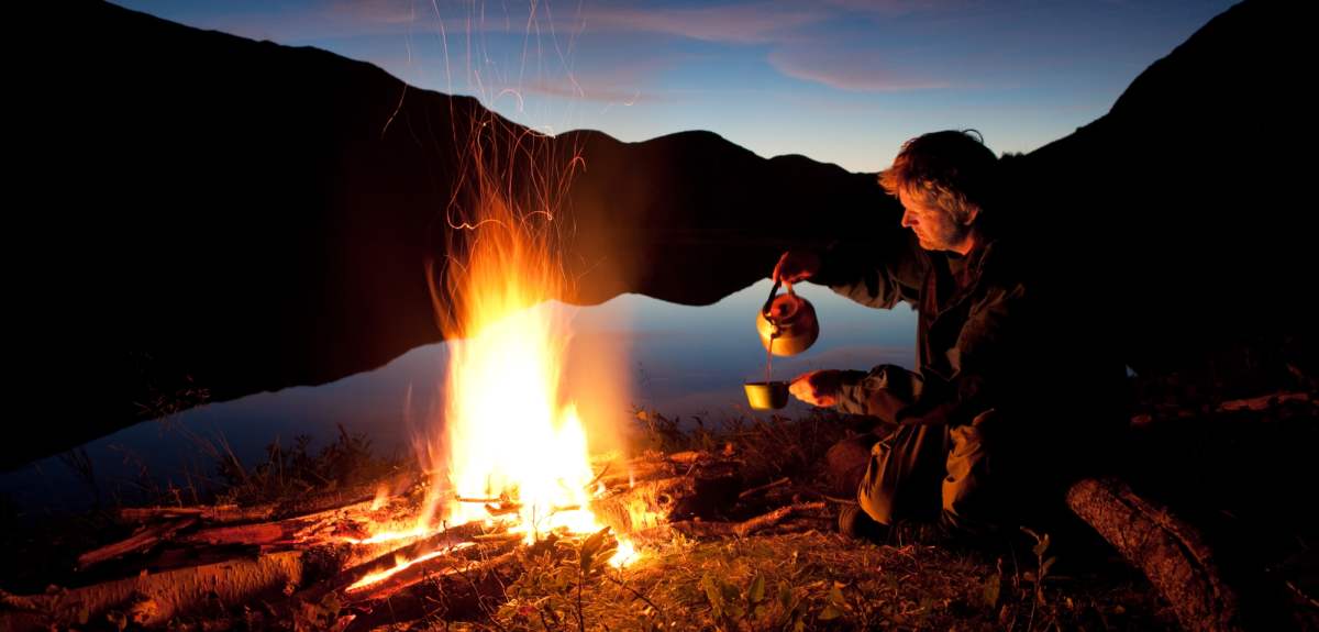 A man making coffee on a campfire in Kautokeino, Norway