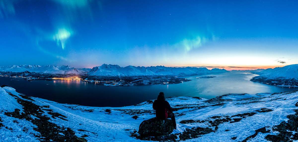 Person watching the northern lights over the Lyngen alps