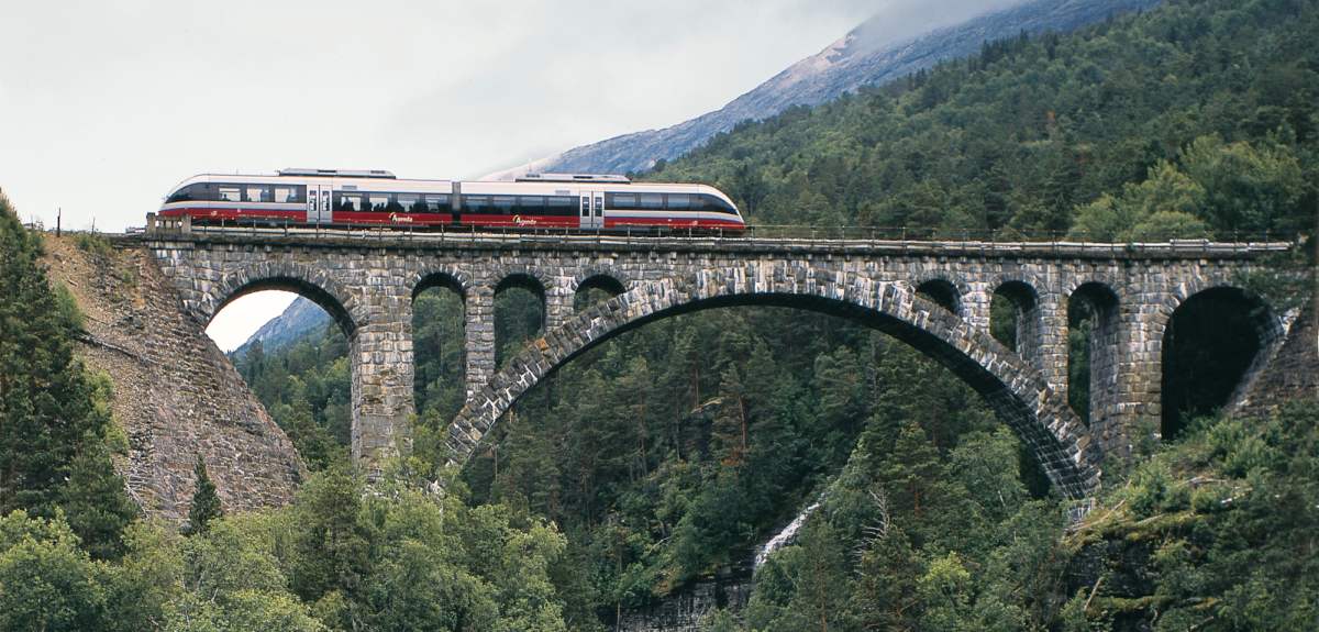 The Rauma Railway is one of the world’s best train journeys. Train crossing Kylling bridge in Rauma, Fjord Norway.