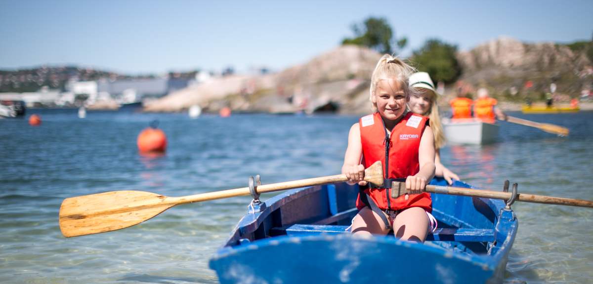 Two children in a rowing boat near Bragdøya outside of Kristiansand, Southern Norway
