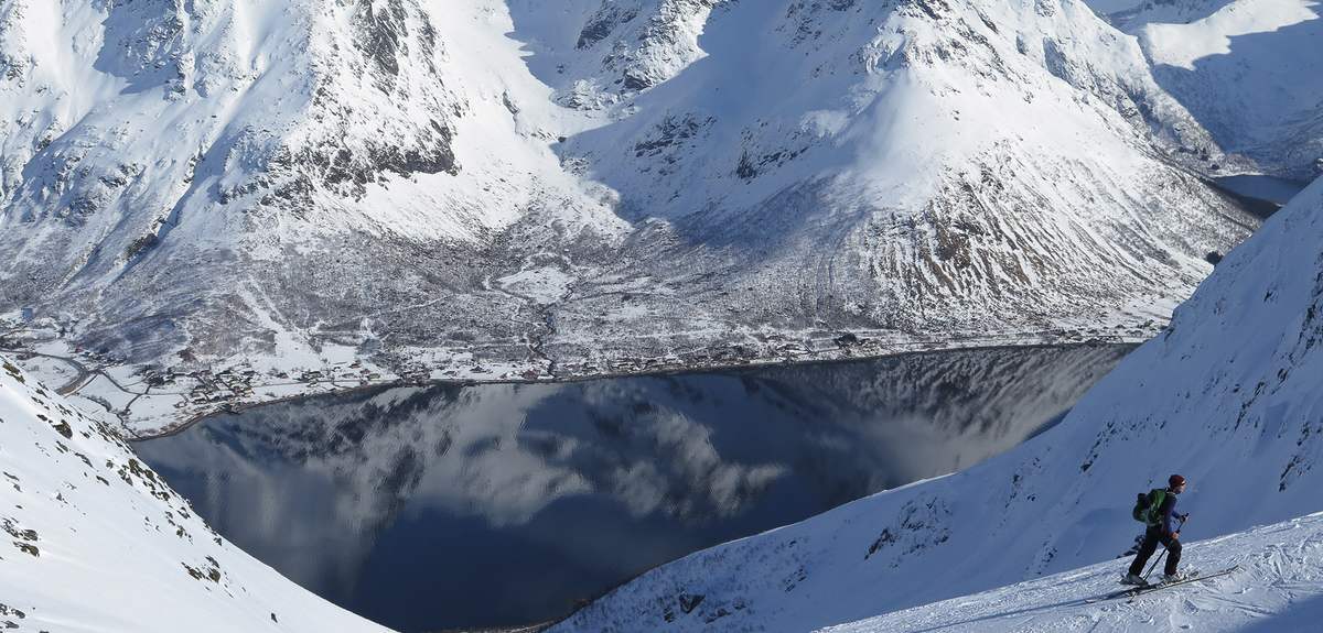 A ski tourer on his way up Mount Kvittinden in Lofoten, Norway