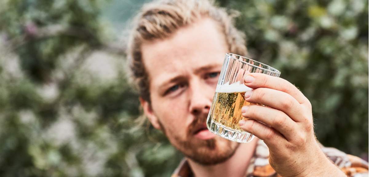 A man tasting Cider from Aga Sideri in Hardangerfjord in Fjord Norway