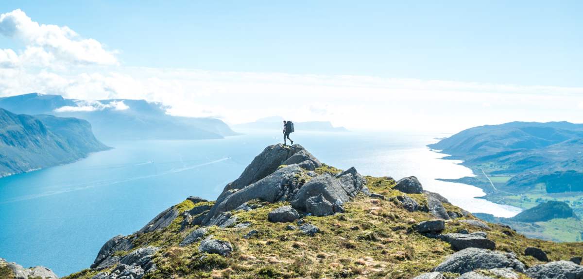 A man standing on top of mount Hornelen