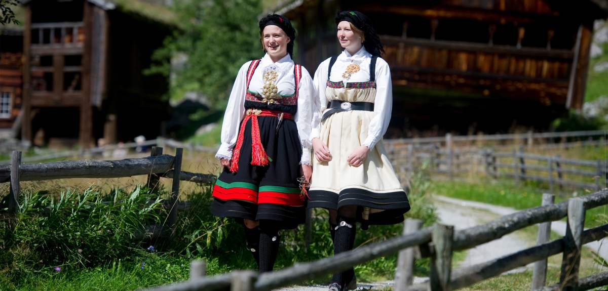 Two girls dressed in Norwegian national costume “bunad” from sustainable destination Setesdal.