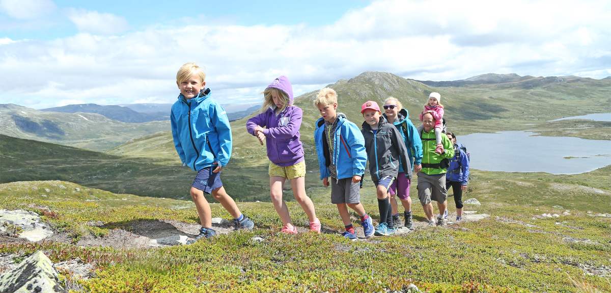 A group of adults and children hiking in the Hemsedal mountains in Eastern Norway