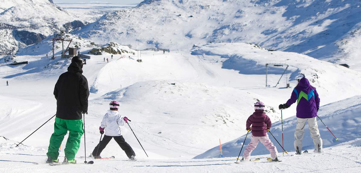 Two adults and two children alpine skiing in Hemsedal