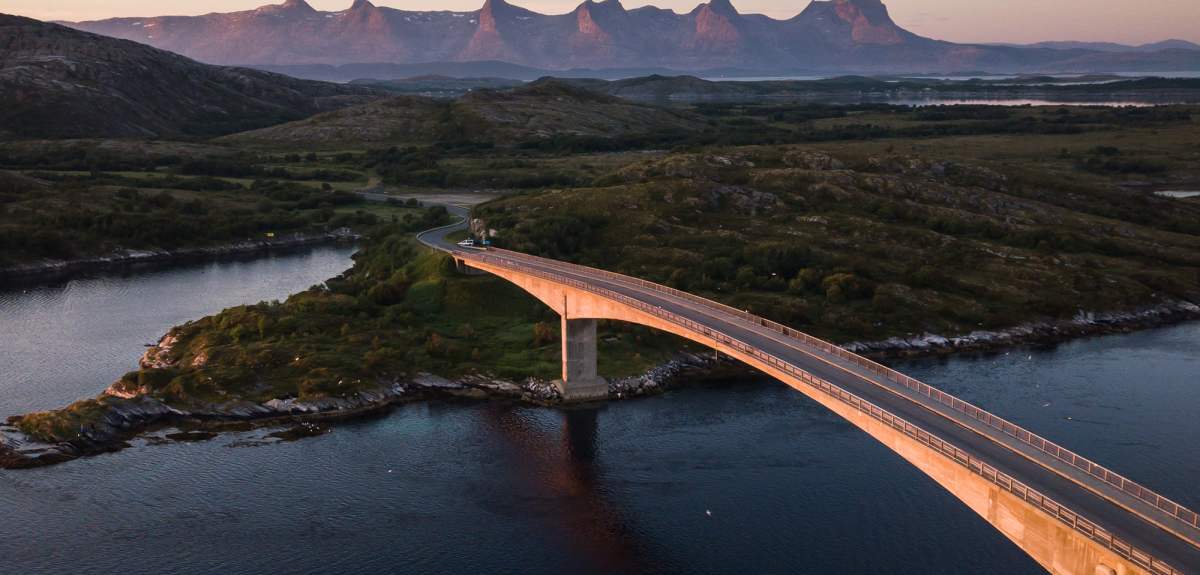 A bridge connecting Herøy to another island in Helegeland, Northern Norway. In the background, the mountain range The seven sisters.