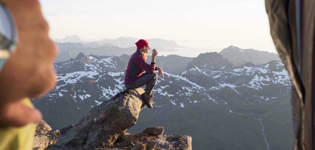 Woman enjoying the view from Higravtindan in Lofoten