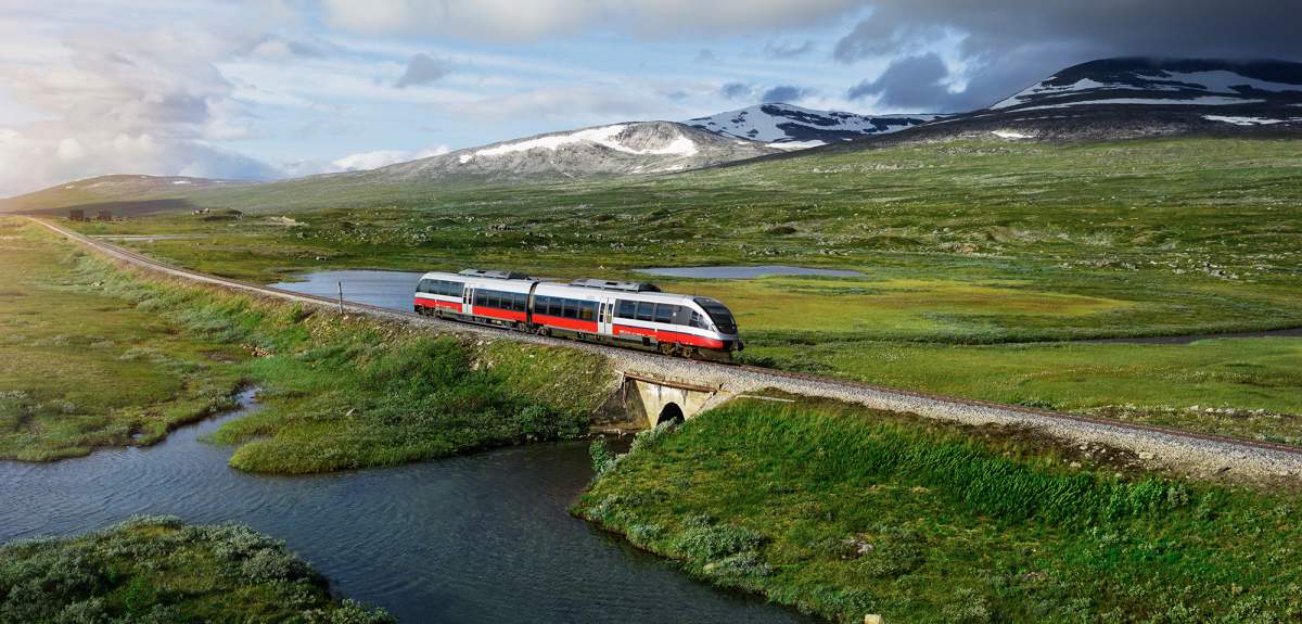 A train passing by a lake in Saltfjellet mountain area in Nordland
