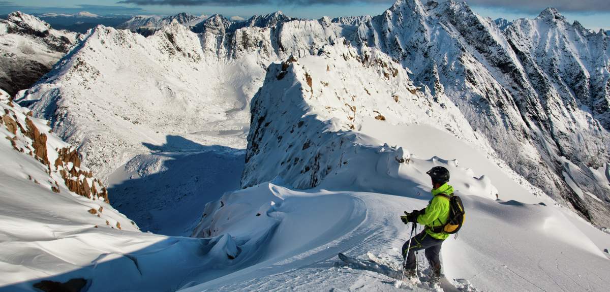 A man on a ski touring trip just before he starts on the descent