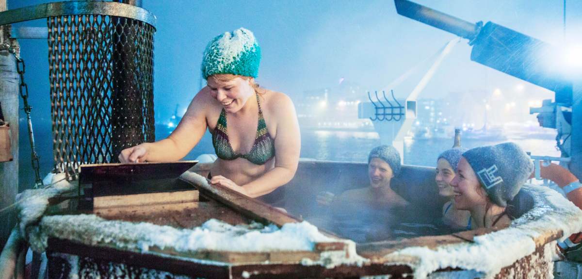 People bathing in the jacuzzi at the Vulkana spa boat in Tromsø harbour, Northern Norway