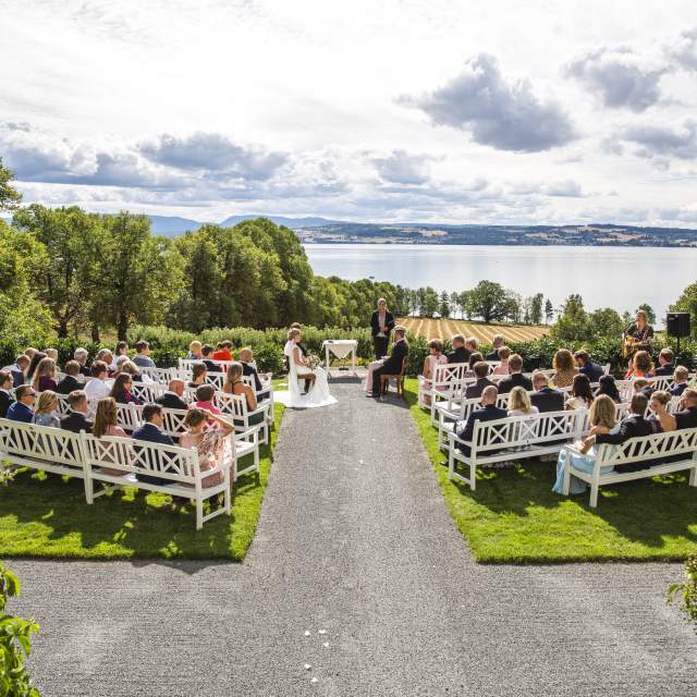 A wedding ceremony outside at the lawn at Hoel Farm by lake Mjøsa in Eastern Norway