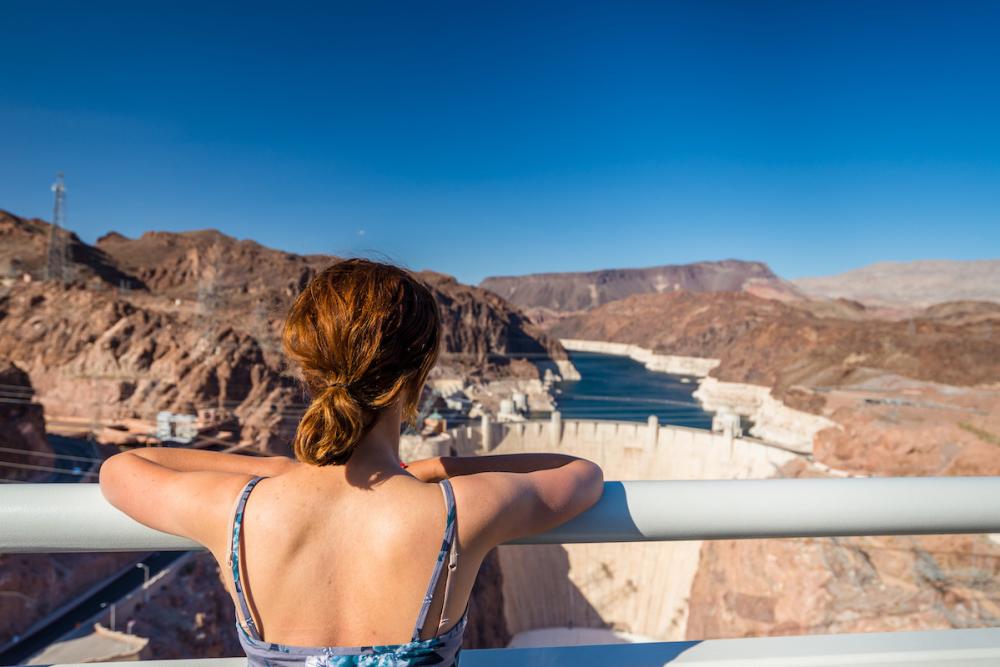 Woman enjoying the view of the Hoover Dam from across the dam.