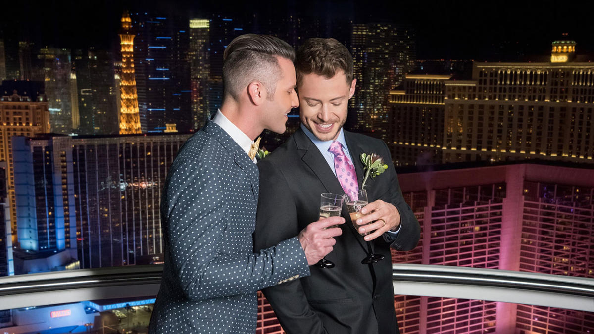 A happy couple toast their drinks on the High Roller Observation Wheel at The LINQ.