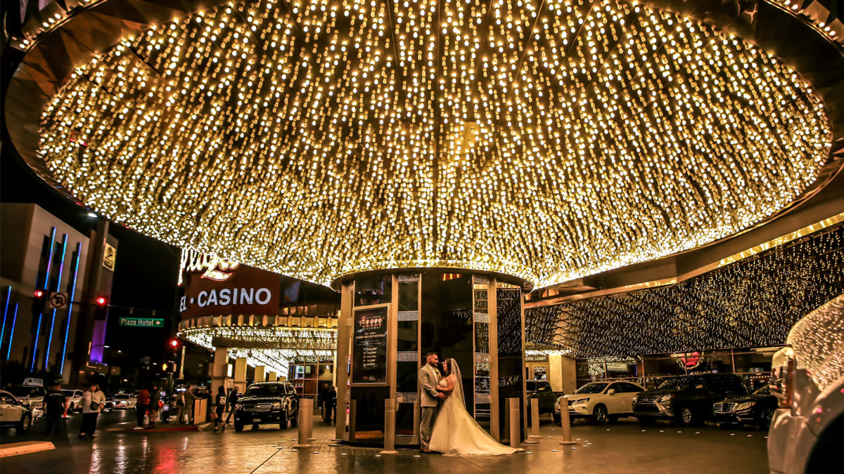 A couple taking wedding photos at Porte cochére at Plaza Las Vegas Hotel & Casino