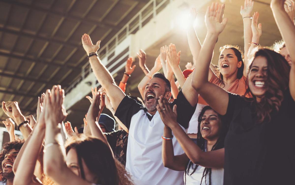 A crowd cheering at a sporting event