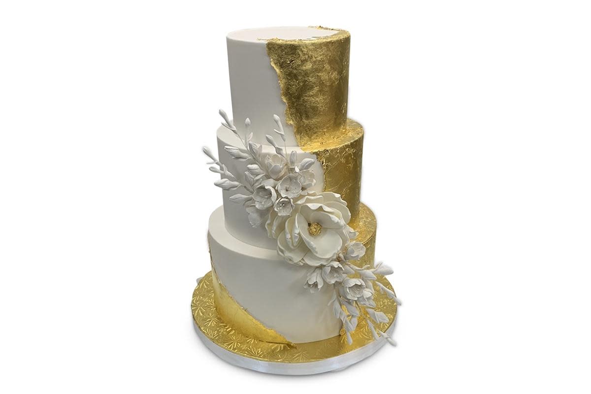 A white and gold wedding cake from Freed's Bakery in Las Vegas