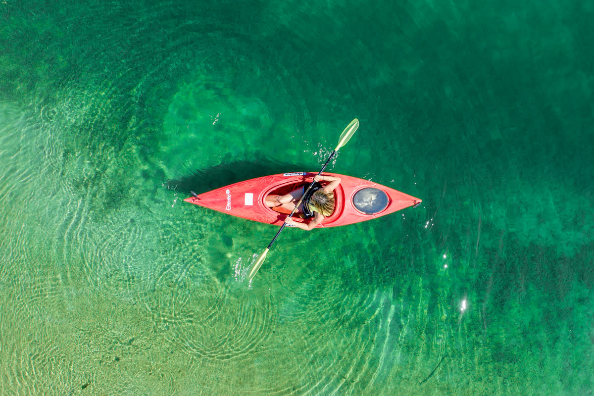 A kayaker in beautiful water.