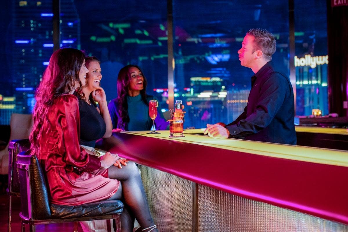 A group of people sitting at the bar at Skybar in Las Vegas