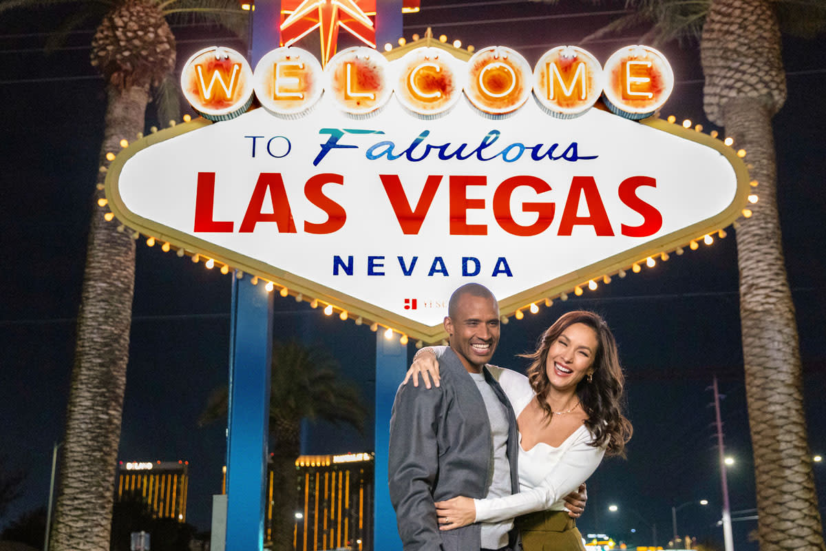 A couple posing happily in front of the famous "Welcome to Fabulous Las Vegas Sign".